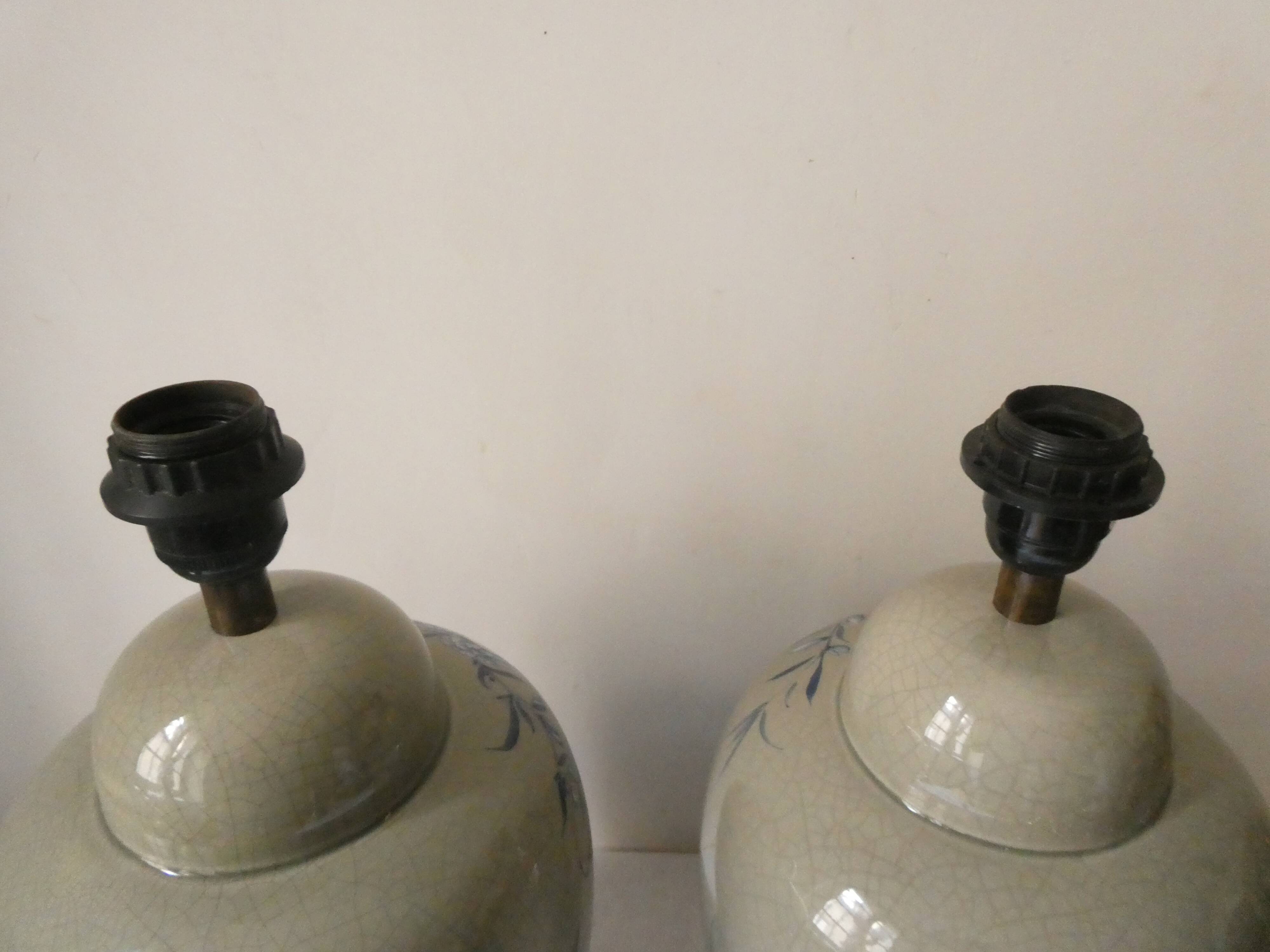 Pair of celadon crackle ceramic lamp bases decorated with flowers.