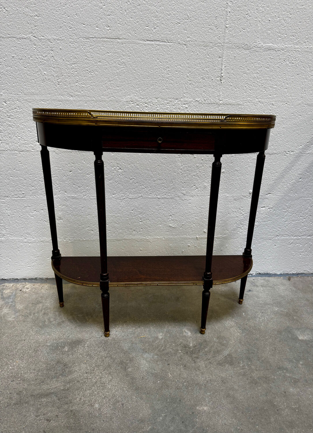 Louis XVI demi-moon console in wood and brass.