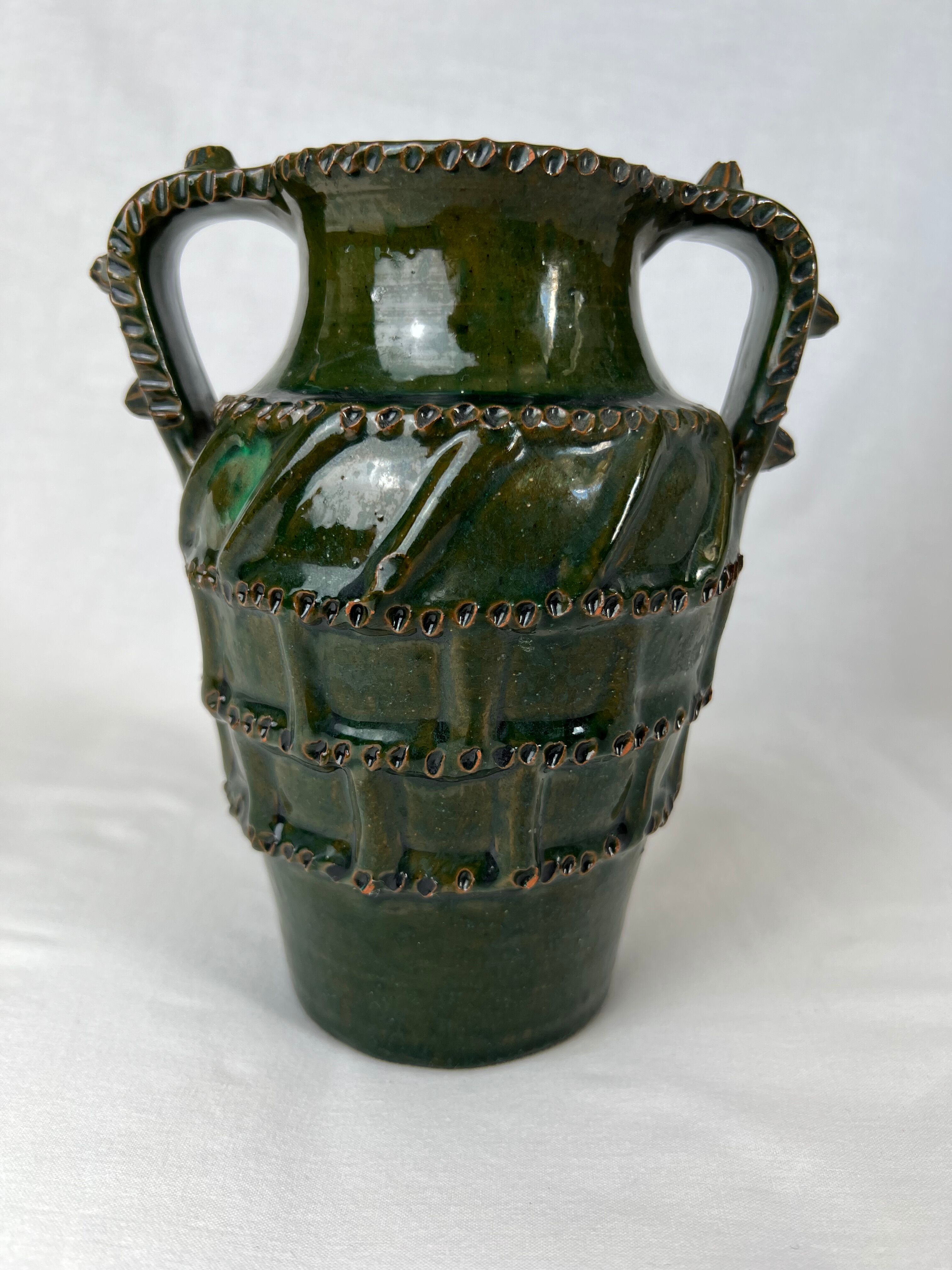 Terracotta jar with dark green handles