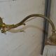 Brass wall sconce with a glass tulip