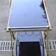 Rolling cart in brass and smoked glass