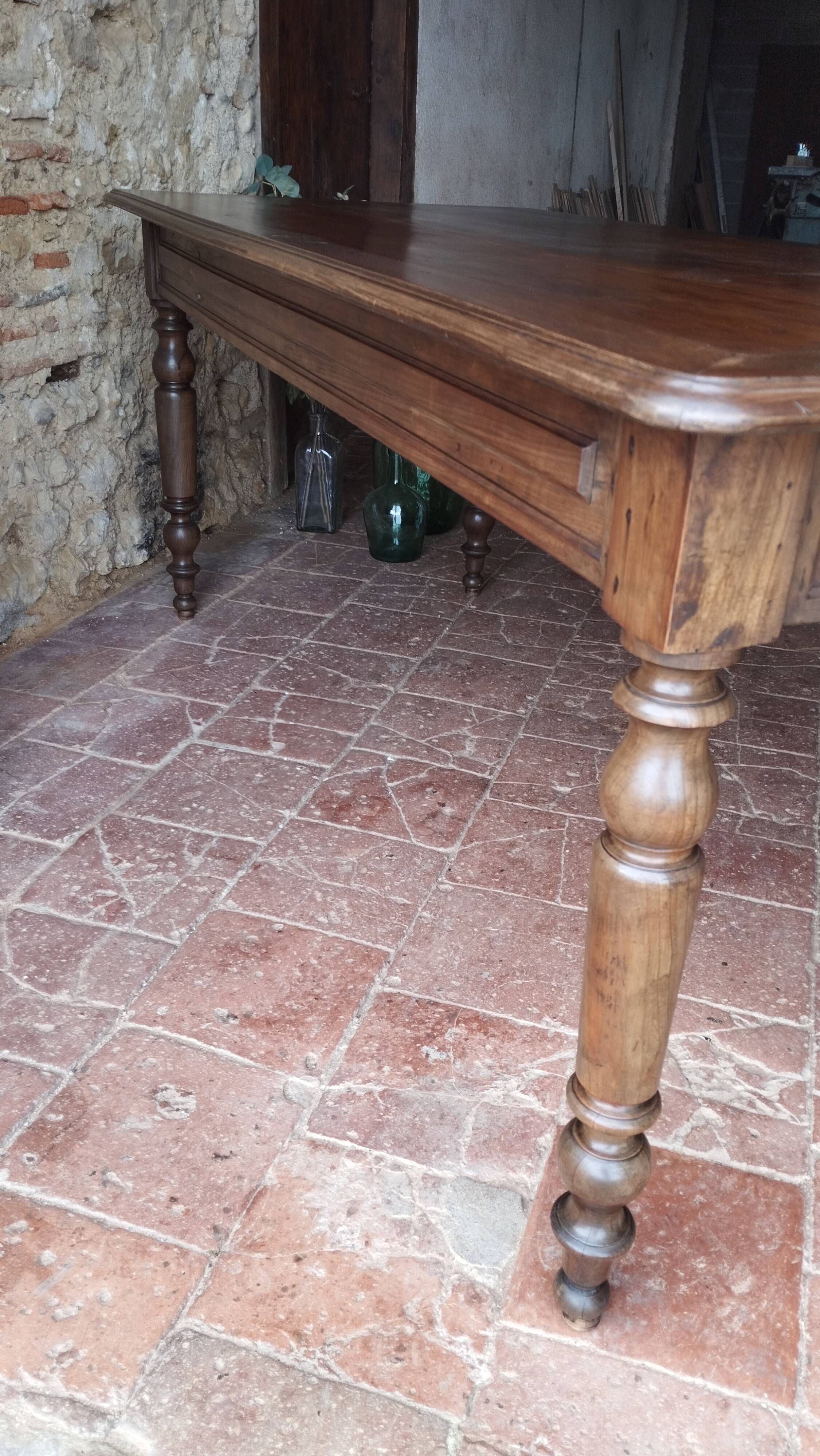 Old French farmhouse table in walnut with turned legs.