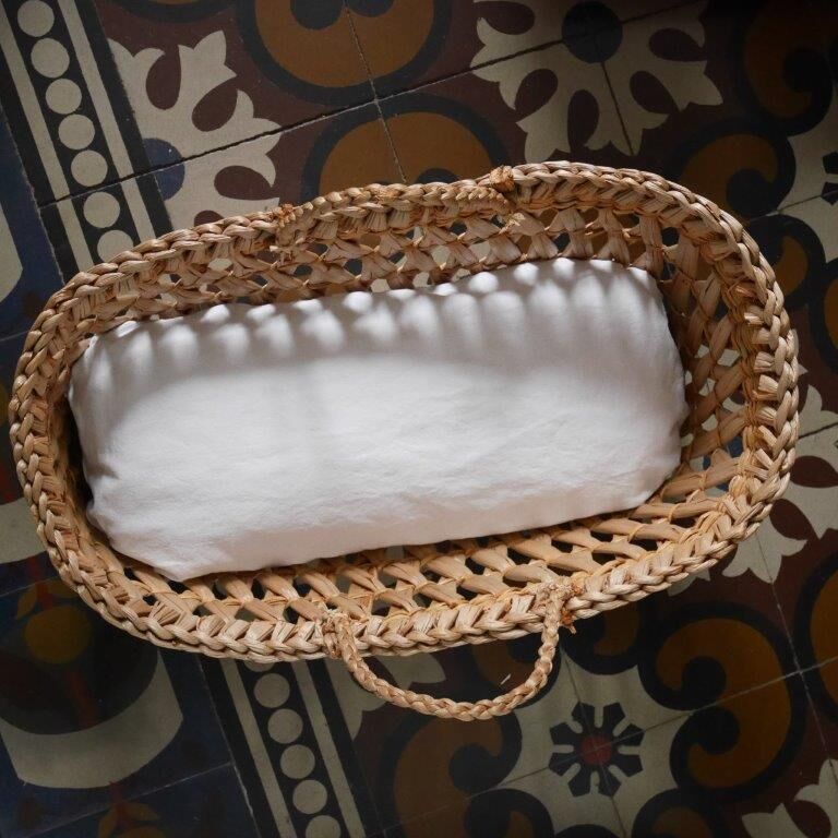 Doll bassinet with its bedding