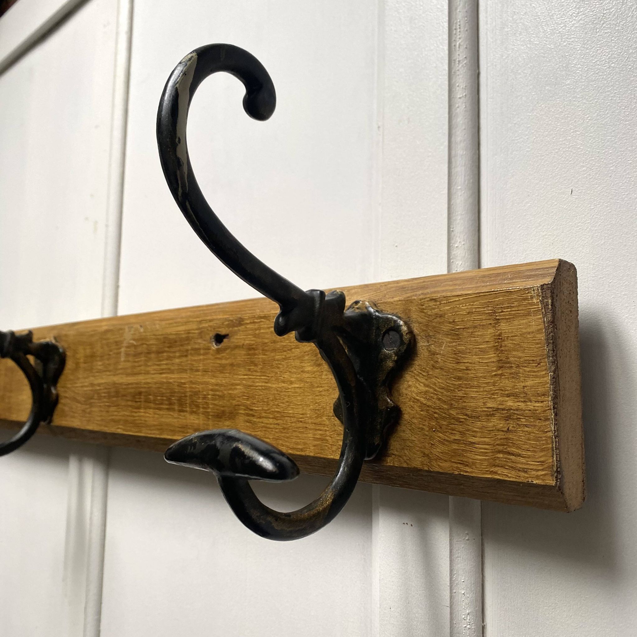 Antique wooden coat rack with metal hooks