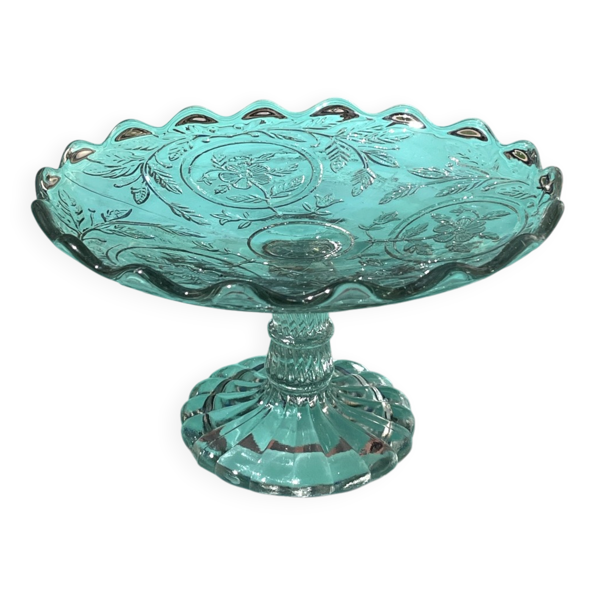 Footed bowl or pressed glass compote with floral decoration for table decor.