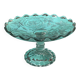 Footed bowl or pressed glass compote with floral decoration for table decor.