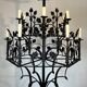 Lustre 12 lumières en fer forgé à décor de trèfles et feuillages