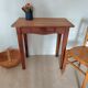Small antique solid wood table in chic country style with a drawer.