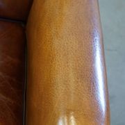 Sheep leather design armchair finished with decorative nails and black piping