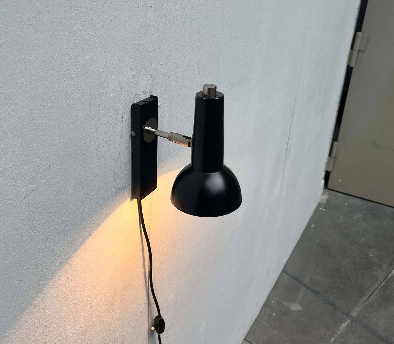 Mid-century German black minimalist wall lamp by Hustadt, 1960s.
