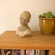 Woman bust in stone and enamel