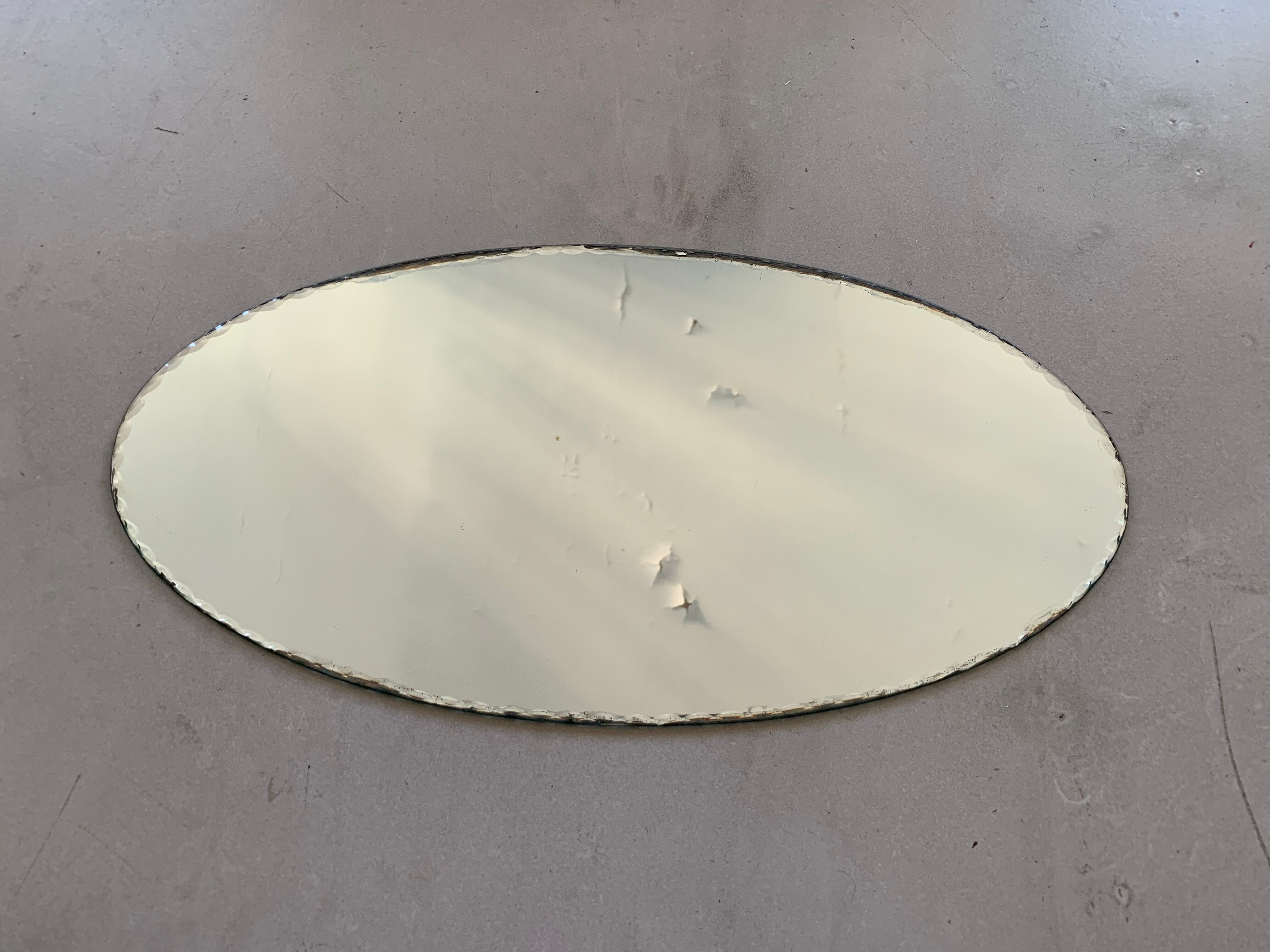 Old beveled oval mirror