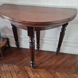 Family half-moon table in walnut hue.