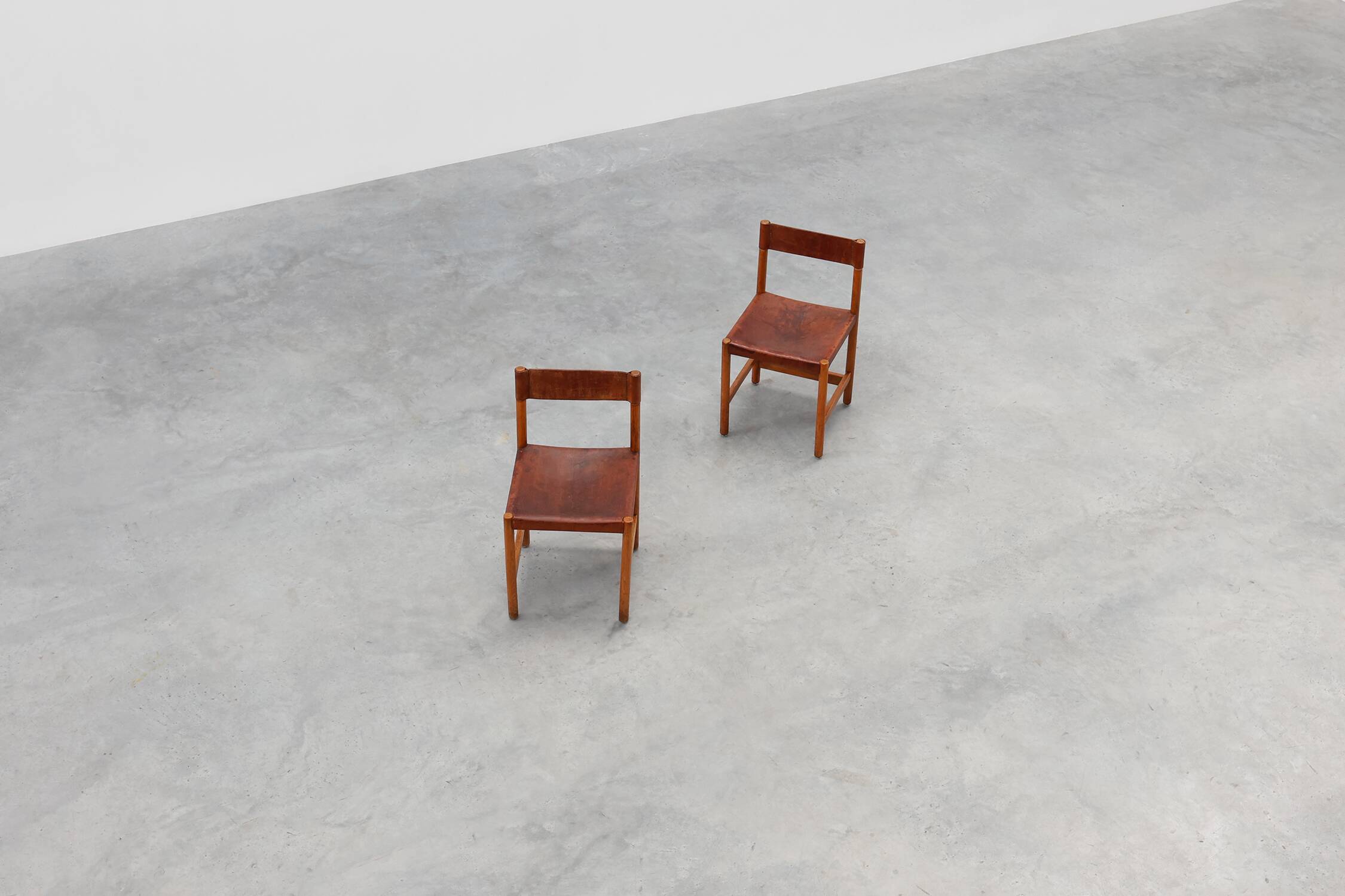 Pair of wood and leather Spanish chairs by Jordi Vilanova, ca. 1960