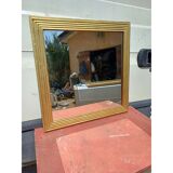 Wooden mirror and gold trim
