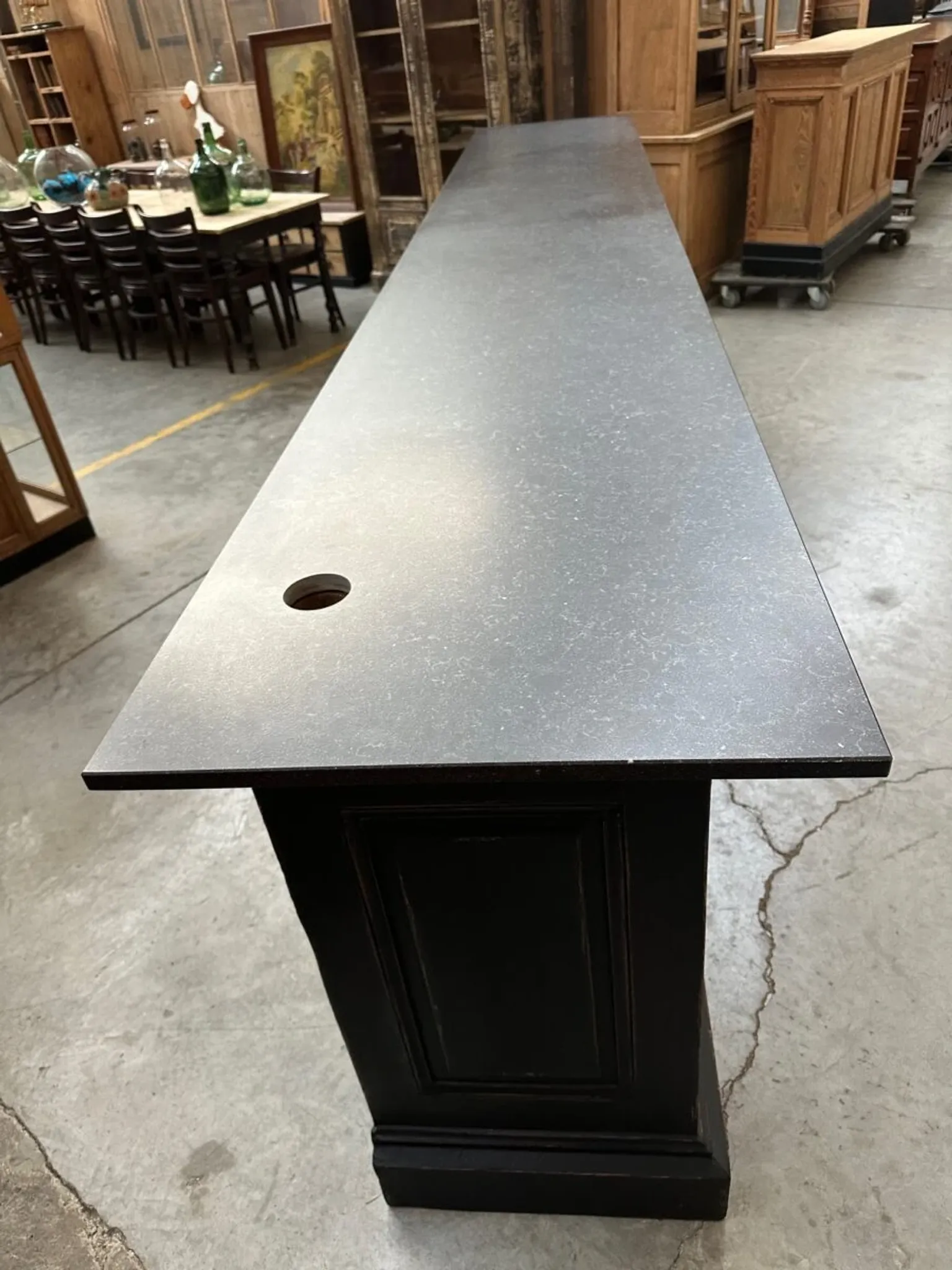 Immense bar counter covered with blue stone.