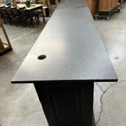 Immense bar counter covered with blue stone.