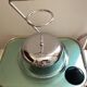 Designer umbrella stand in chrome metal and wood.