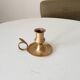 Antique hand candlestick in solid gilded brass.