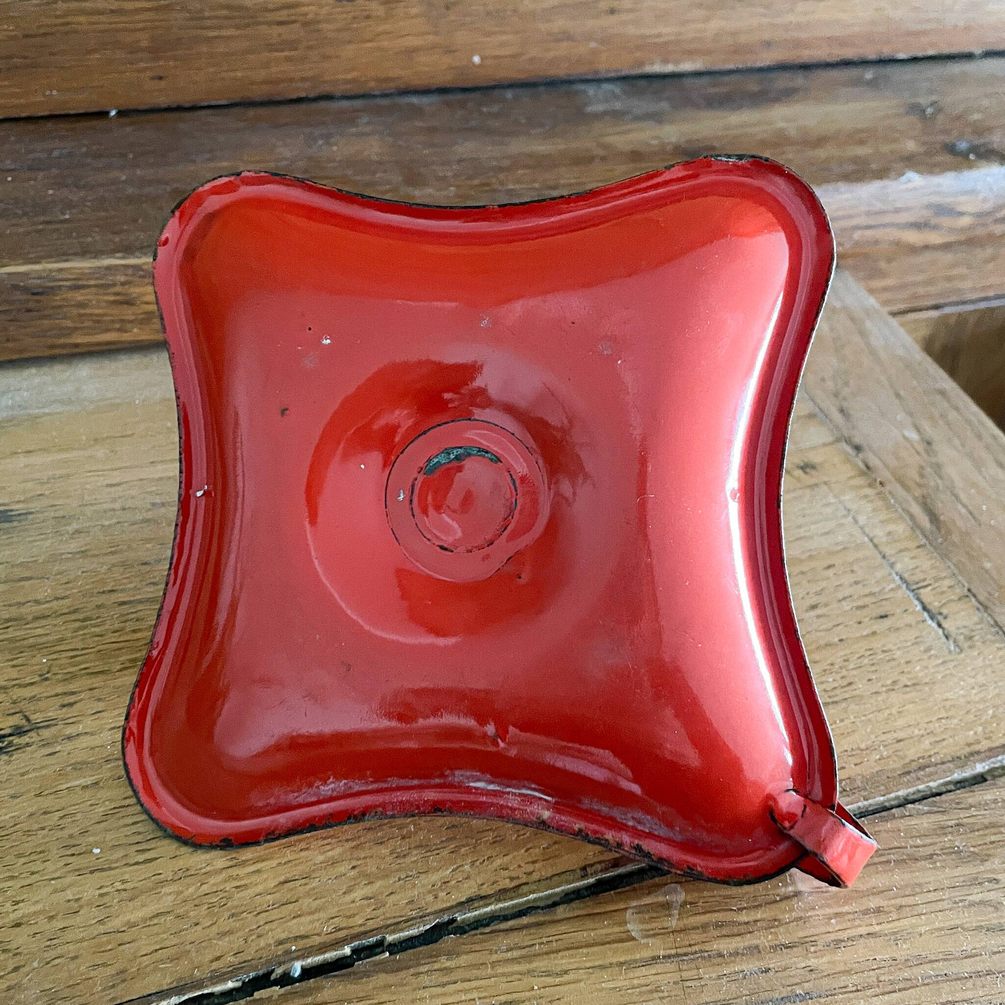 Red enamelled sheet metal candle holder