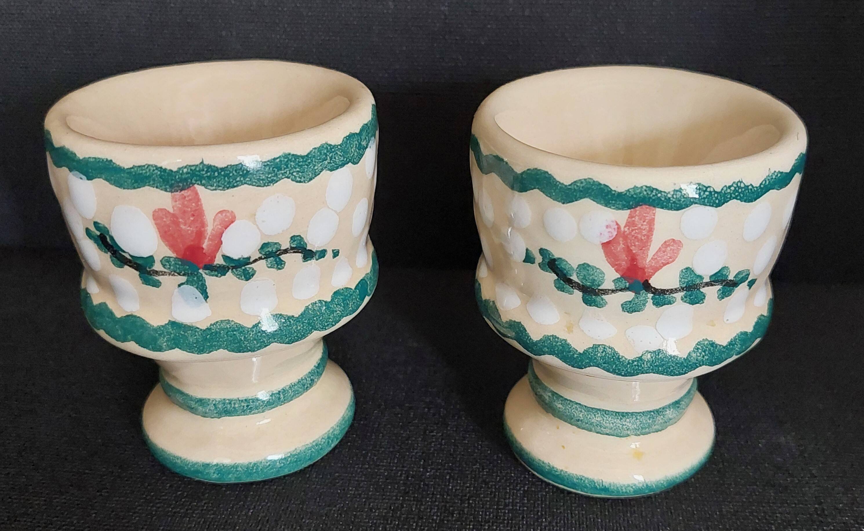 Pair of vintage earthenware egg cups with hand-painted decoration