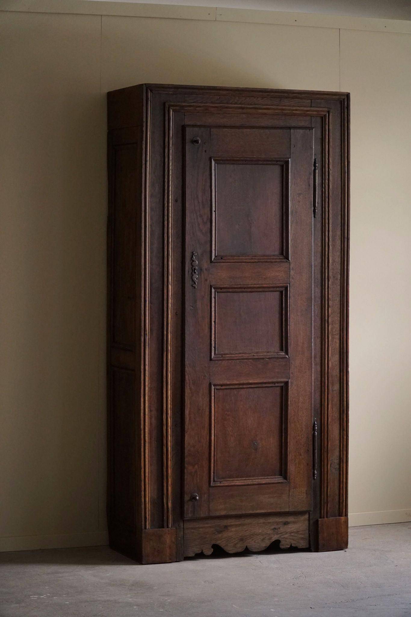 Tall antique oak wardrobe, made by a French cabinetmaker, late 19th century.