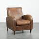 Sheepskin armchair in a light cognac colour with matching piping
