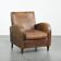Fauteuil en peau de mouton de couleur cognac clair avec passepoil assorti.