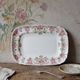 Antique Longchamp serving platter with polychrome daisies in ironstone.