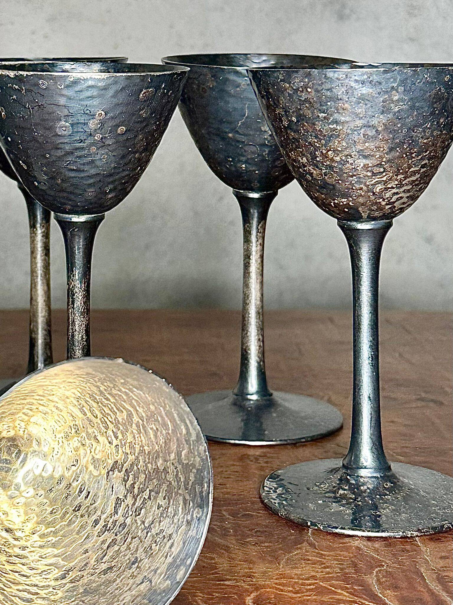 Set of six hammered metal goblets.