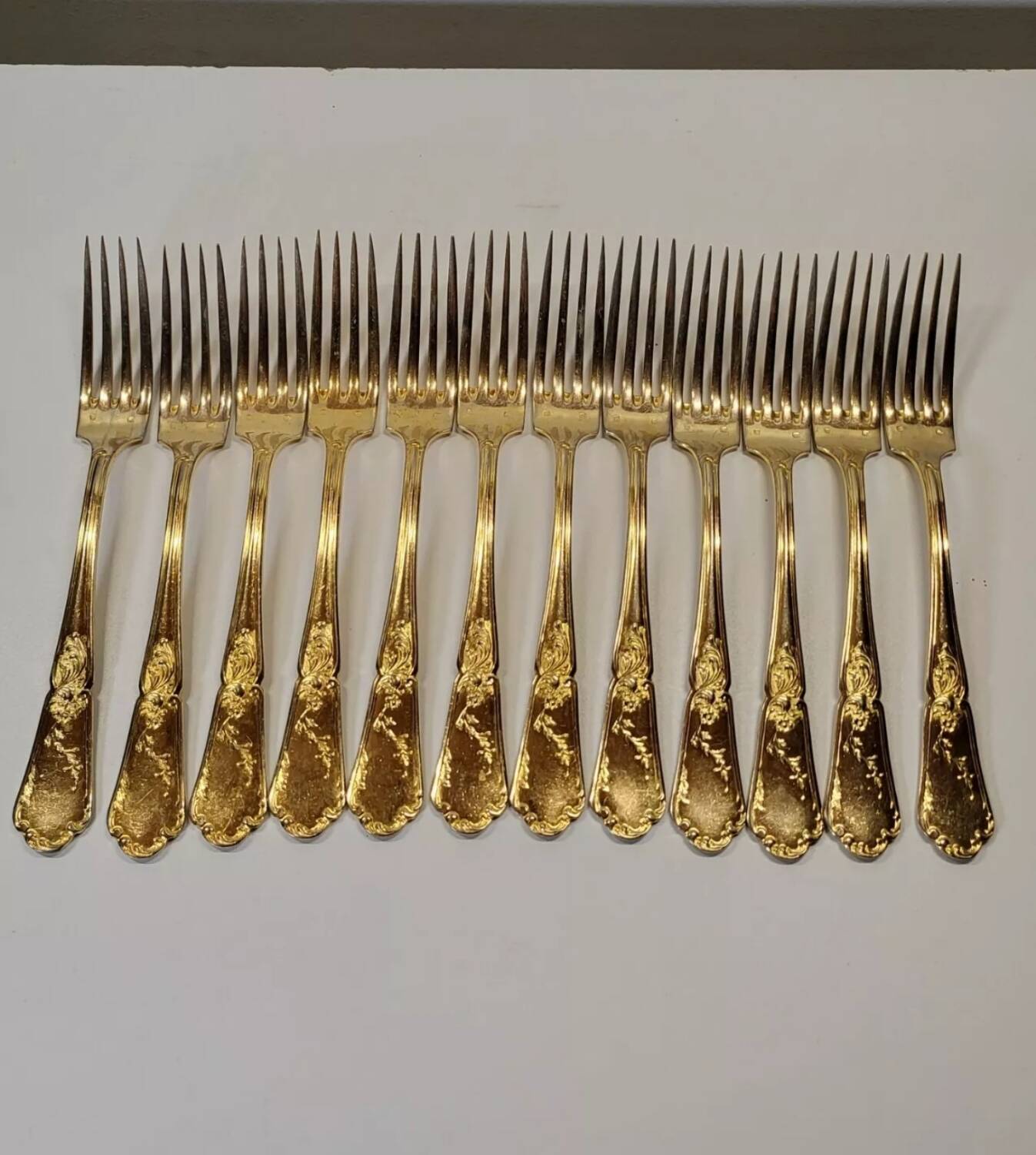 12 Table Forks in gold metal