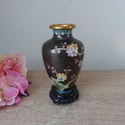 Small black cloisonné vase decorated with yellow and pink cherry blossoms, vase on wooden base