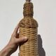 Antique woven wicker bottle