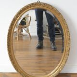 Beveled oval mirror and gilded wood frame