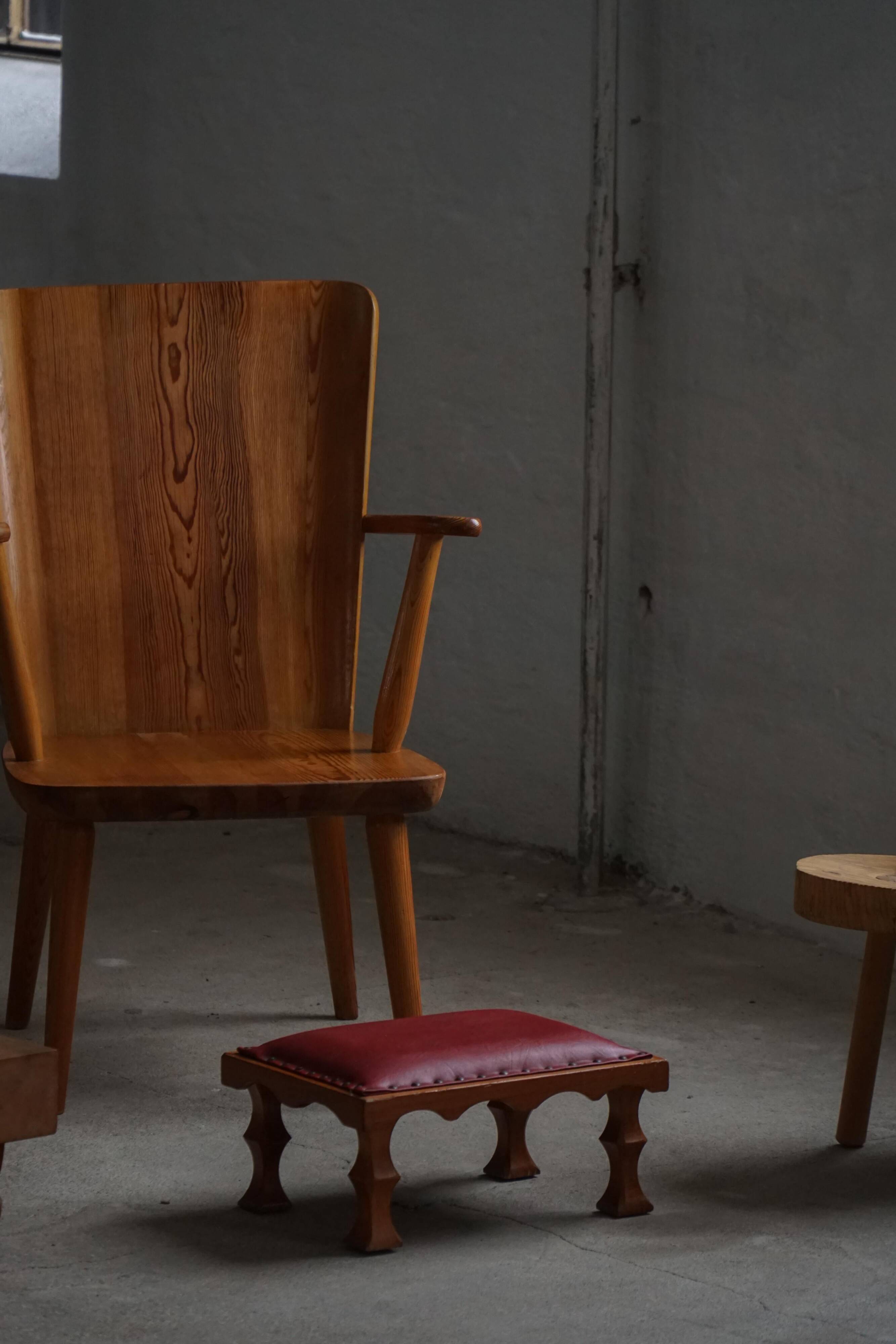 Danish sculpted oak stool from the mid-20th century with a red leather seat, 1950s.