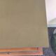 Renovated vintage bedside table in wood, with tapered legs – Matt green & gold background