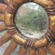 Miroir soleil en bois et stuc doré, années 50