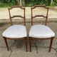 2 Louis XVI period chairs in solid wood and grey fabric.