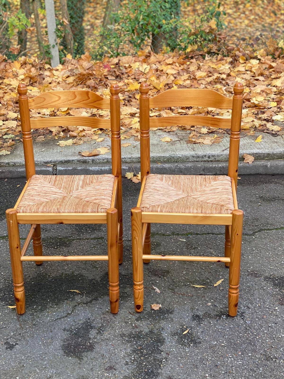 2 straw-seated chairs in light-colored solid wood