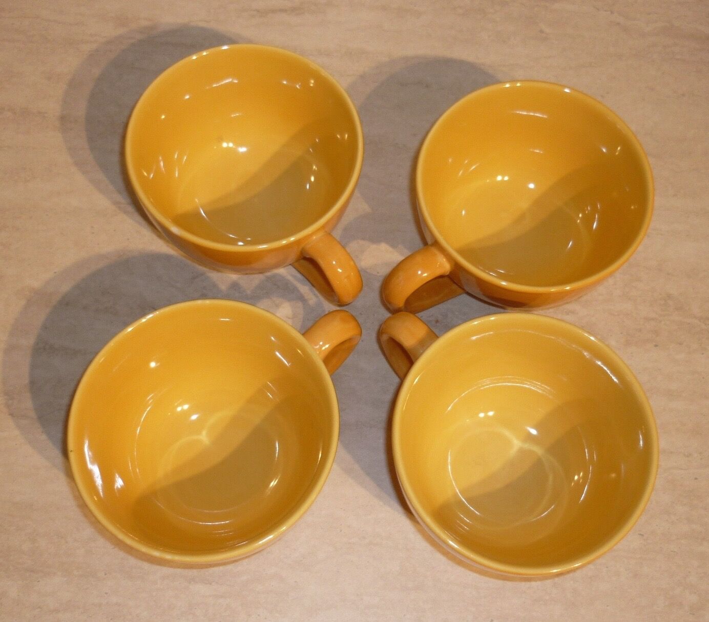 4 yellow and orange ceramic cups