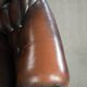 Brown cow leather Chesterfield office chair on wheels in English style