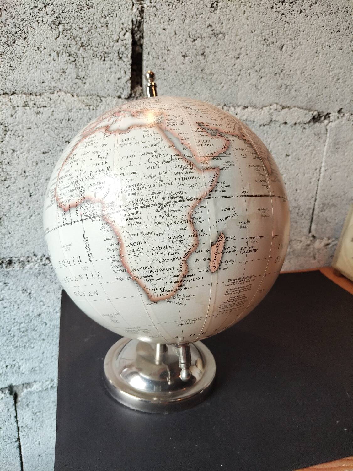 Decorative terrestrial globe on silver metal stand – explorer style