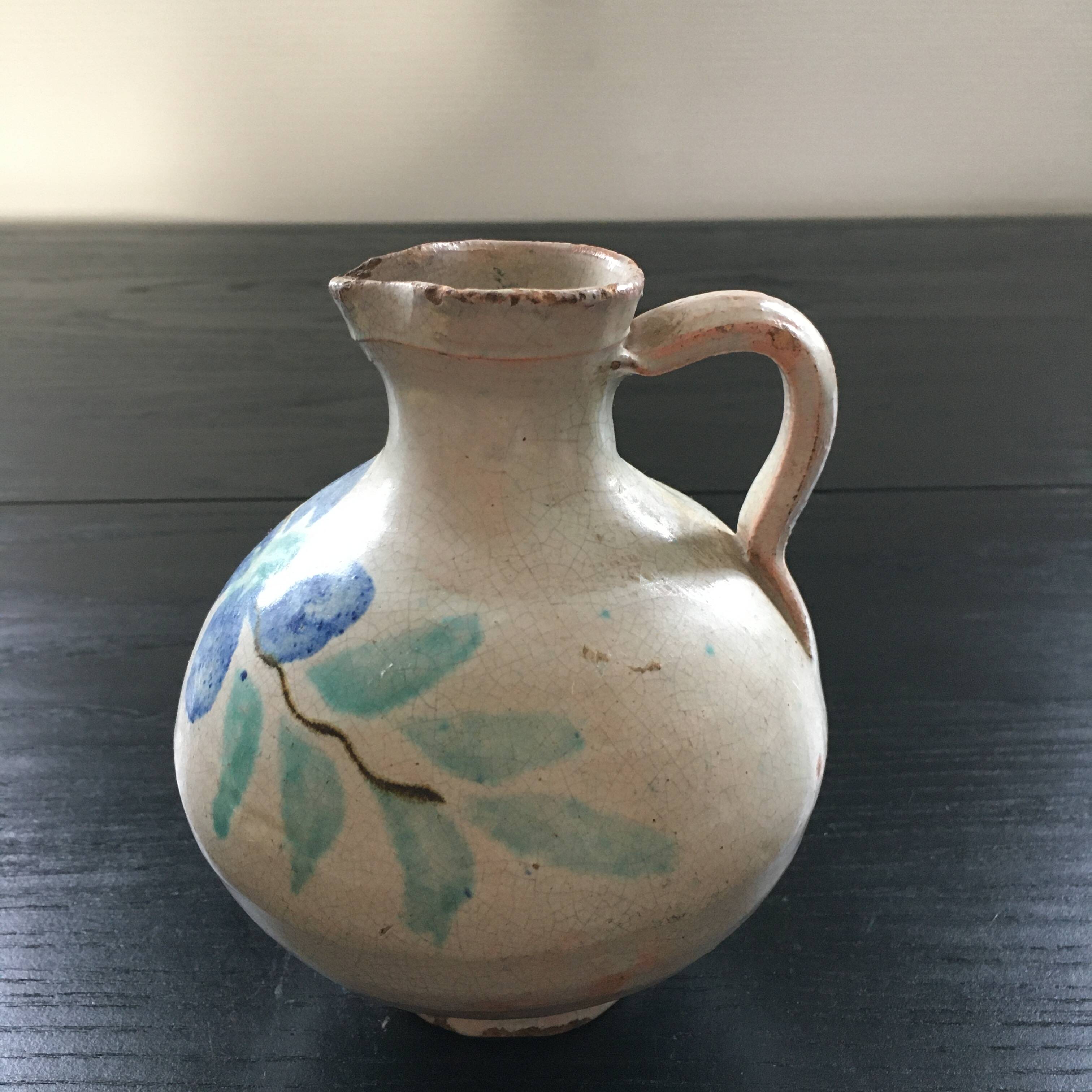 Antique pitcher with floral decoration