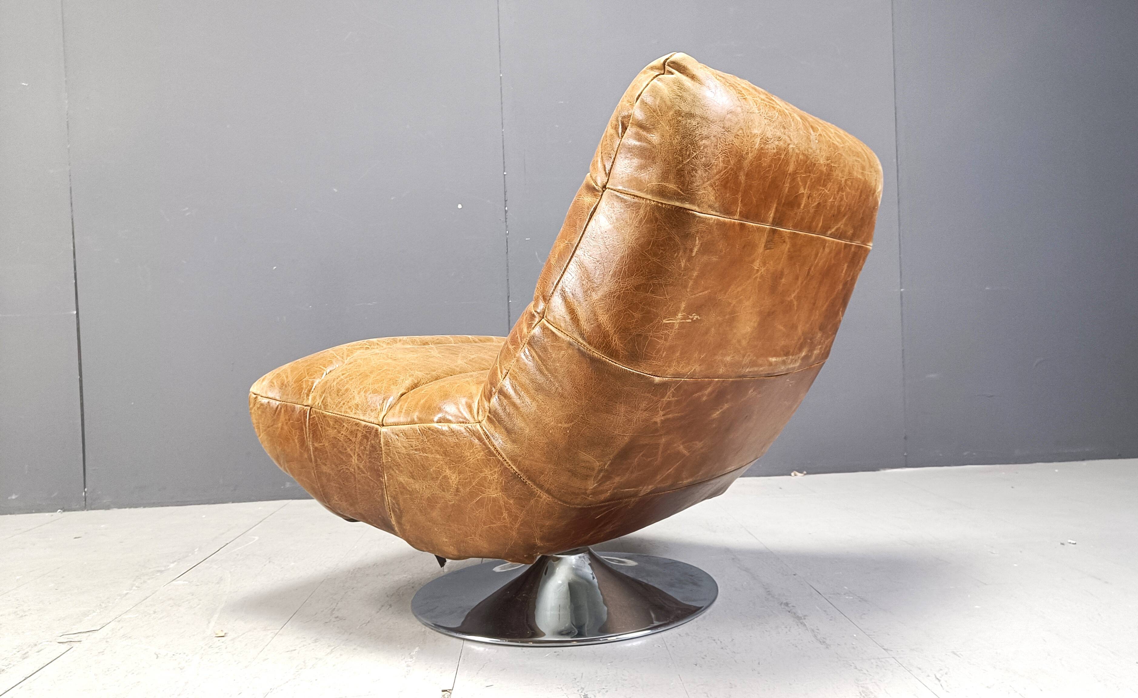 Vintage leather swivel chair with stool, 1970s