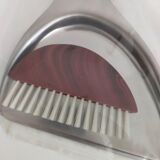 Picks up new vintage shovel and sweeper crumbs