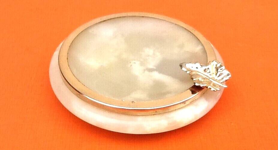 1970s Onyx ashtray with a gold metal rim.