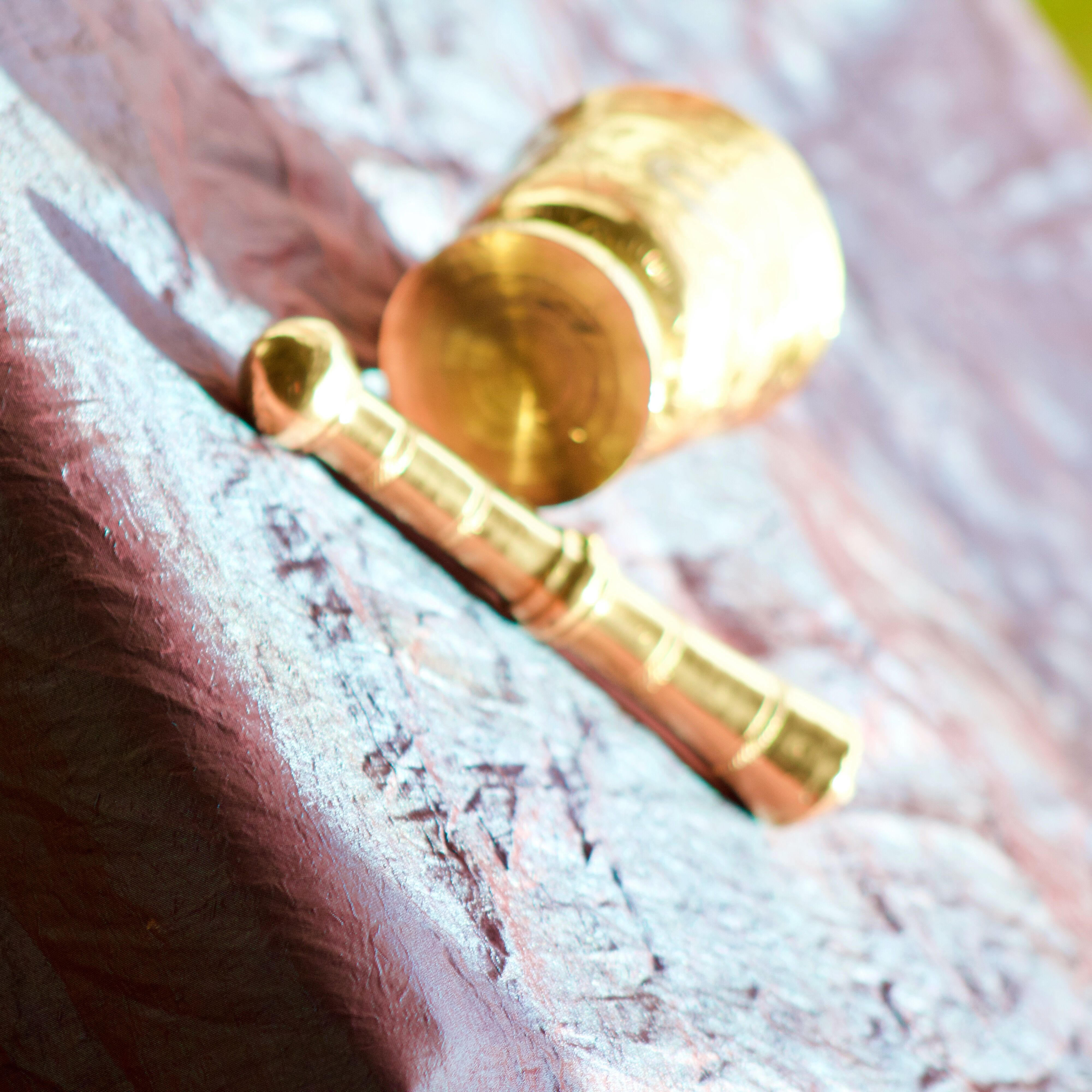 Mortar and its brass pestle with oriental gold and silver motifs