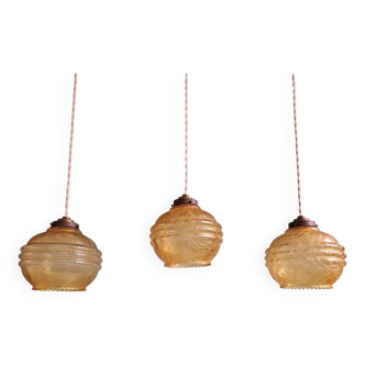 Trio of Art Deco pendant lights in amber crackle glass, 1920s-30s
