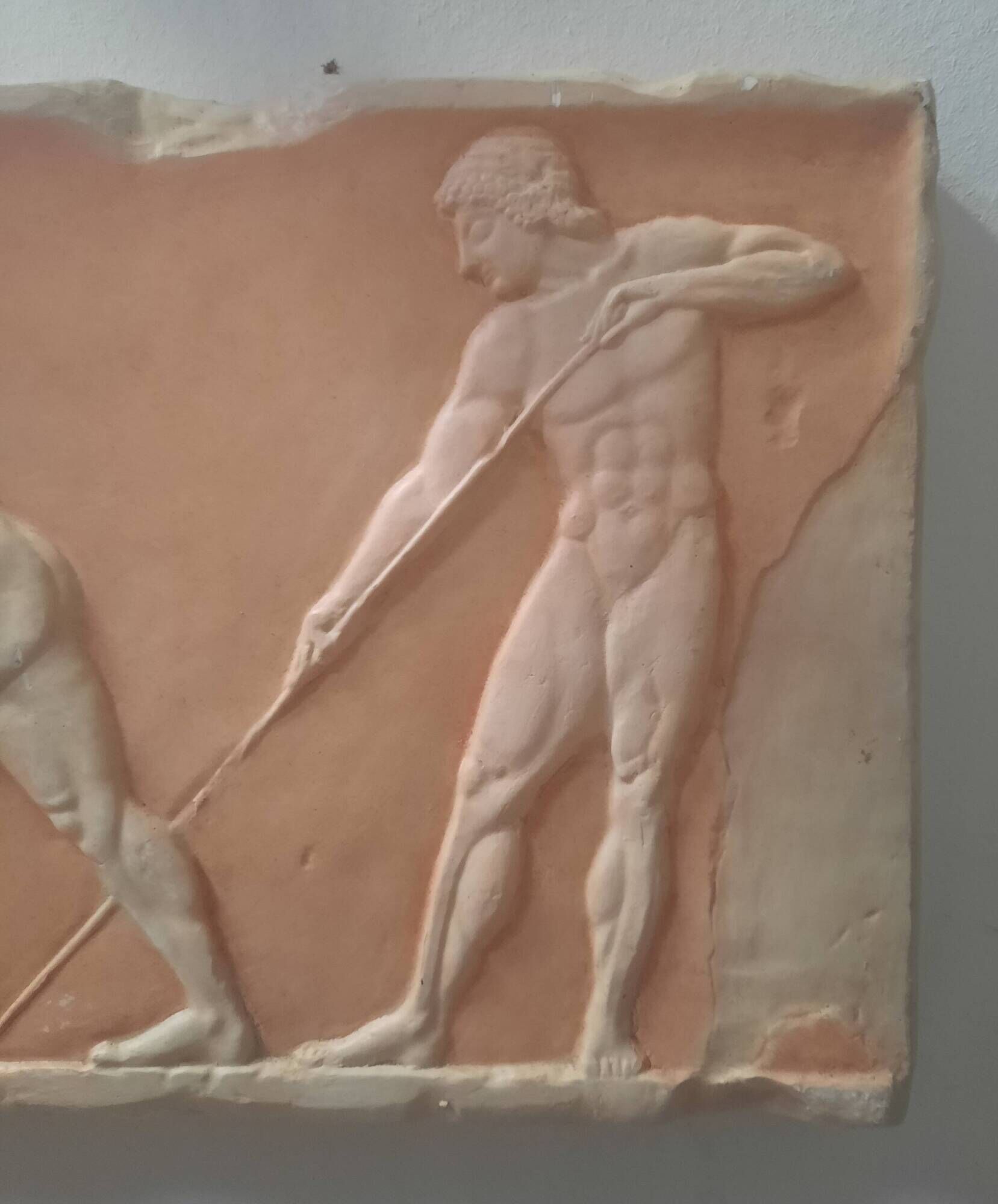 Bas-relief in the antique style featuring athletes.