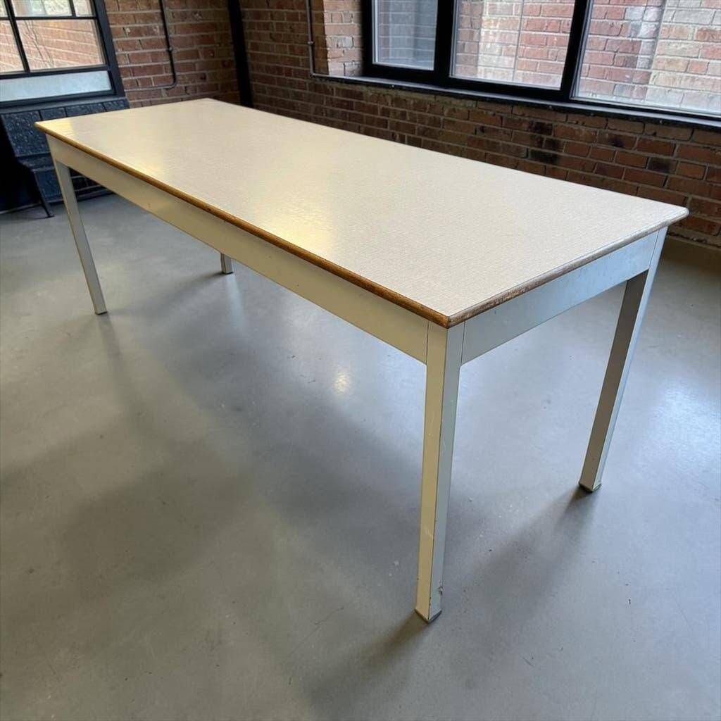 Vintage industrial table with a Formica top and wooden accents.
